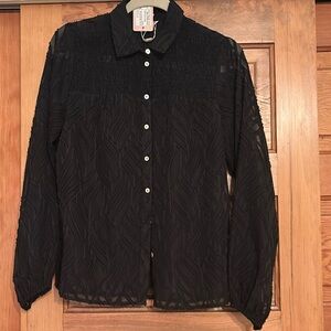 This blouse has an a print similar to an animal print. It is see though black.